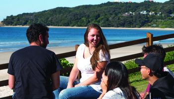 Students sitting at the beach